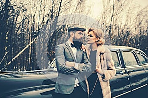 Escort of girl by security. Bearded man and sexy woman in coat. Travel and business trip or hitch hiking. Couple in love