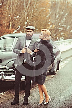 Escort of girl by security. Couple in love on romantic date. Bearded man and sexy woman in fur coat. Travel and business