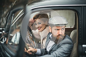 Escort of girl by security. escort concept with bearded driver and luxury girl in retro car.