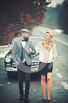 Escort of girl by security. escort concept with bearded driver and luxury girl in retro car.