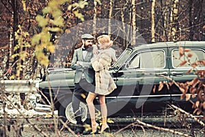 Escort of girl by security. Travel and business trip or hitch hiking. Bearded man and sexy woman in fur coat. Retro