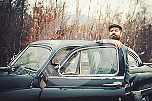 Escort man or security guard. Bearded man in car. Call boy in vintage auto. Retro collection car and auto repair by