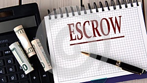 ESCROW - word in a notebook on the background of a calculator and banknotes