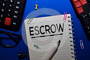 ESCROW write on book isolated on wooden table. Medical or Finance concept