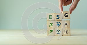 ESG concept of environmental, social and governance. Sustainable corporation development. Hand holds wooden cubes with abbreviatio