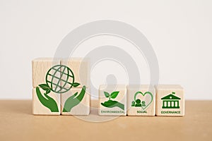 ESG concept of environmental, social and governance. Sustainable and ethical business. ESG text with ESG icon on wooden cube