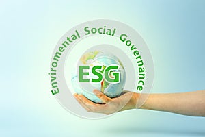 ESG modernization environmental social governance conservation and CSR policy. Earth globe in hands on a blue background