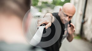 Eskrima and kapap instructor demonstrates machete weapon fighting technique