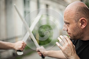 Eskrima and kapap instructor demonstrates machete weapon fighting technique