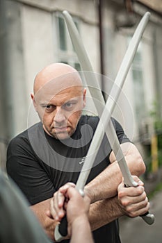 Eskrima and kapap instructor demonstrates machete weapon fighting technique