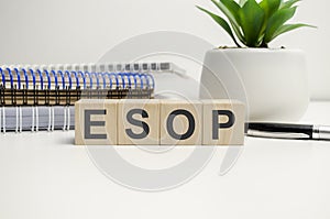 esop sign on the wooden cubes and notepads. Business concept