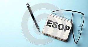 ESOP text written on a notepad on the blue background