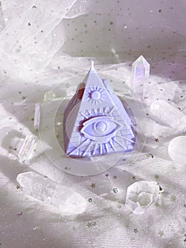 Esoteric candle clairvoyant pyramid surrounded by crystals