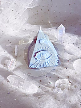 Esoteric candle clairvoyant pyramid surrounded by crystals