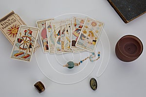 Esoteric table with astrological wheel, magic pendulum, tarots, healing stones