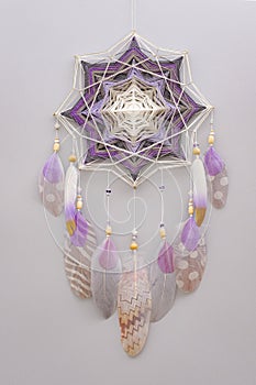 Esoteric woven mandala magical dreamcatcher  on grey background