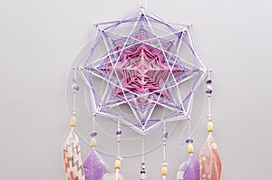 Esoteric woven mandala magical dreamcatcher  on grey background