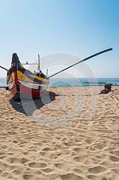 ESPINHO, PORTUGAL - JULY 16, 2017: Arte Xavega typical portuguese old fishing boat on the beach in Paramos, Portugal.