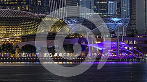 The Esplanade Theatres on the Bay in Singapore at dusk, with beautiful reflection in water night timelapse