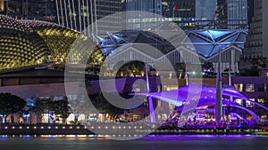 The Esplanade Theatres on the Bay in Singapore at dusk, with beautiful reflection in water night timelapse