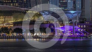 The Esplanade Theatres on the Bay in Singapore at dusk, with beautiful reflection in water night timelapse