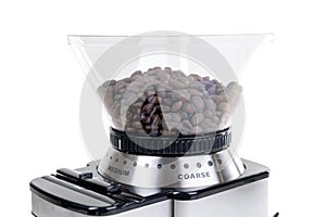 Espresso bean coffee grinder. Brand new clean machine over white, close up of hopper filled with roasted beans