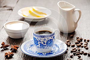 Espresso in blue cup with lemon and honey on table