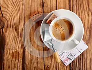 Espresso, Bricks, Trowel and Blueprint on a Table photo