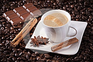 Espresso with coffee beans cinnamon sticks anise stars and chocolate