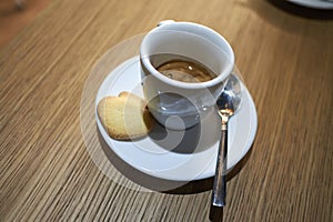 Espresso coffee and a biscuit