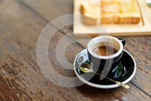 Espresso coffee with and bread on wooden table