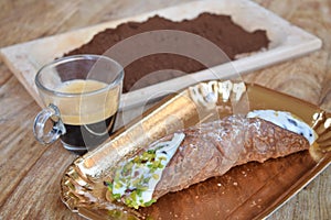 Espresso coffee  with a cannolo and gound coffee