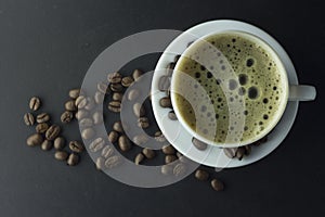 Espresso coffee cup isolate with coffee beans on black background copy space