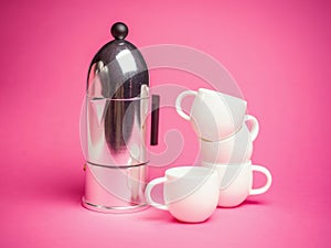 Espresso coffee cups over a pink background