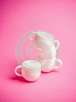 Espresso coffee cups over a pink background