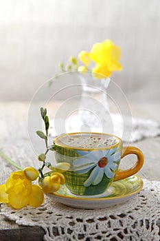 Espresso coffee with flowers and crochet place mat