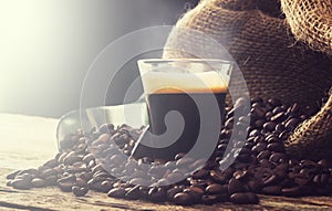 Espresso coffee in glass cup with coffee beans.