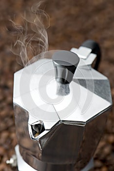 Espresso coffee maker on coffee beans background