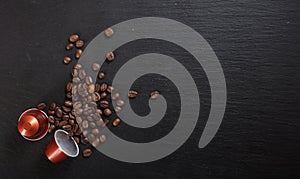 Espresso coffee pods and coffee beans on black background, Top view with copy space