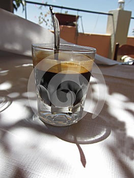 Espresso coffee with rum, sugar and lemon rind in a shot glass. Typical recipe of Livorno, Italy