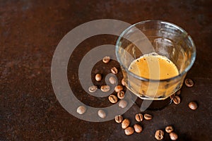 An espresso coffee shot on rustic table background.