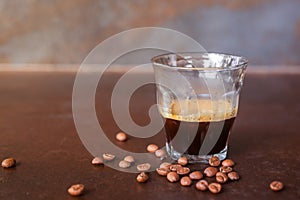 An espresso coffee shot on rustic table background.