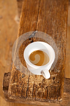 Espresso coffee in thick white cup wooden bench photo