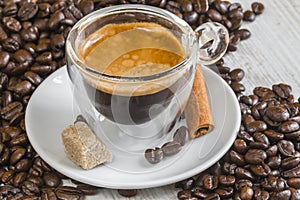 Espresso coffee in transparent glass with golden crema photo