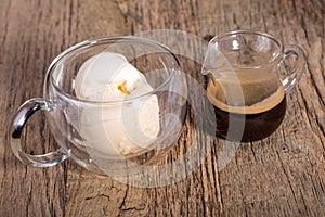 Espresso coffee and Vanilla ice cream in double walled glass italian dessert, on the rustic wooden table