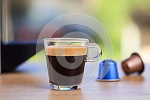 Espresso cup and coffee capsules on blur background, Closeup view with details