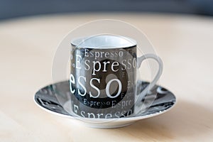 An espresso cup with the letters