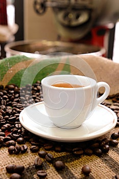 Espresso cup with coffee beans in a coffee roasting photo