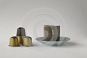 Espresso cup and saucer with four coffee pods