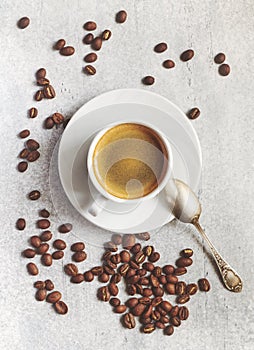 Espresso cup on a saucer with freshly roasted coffee beans